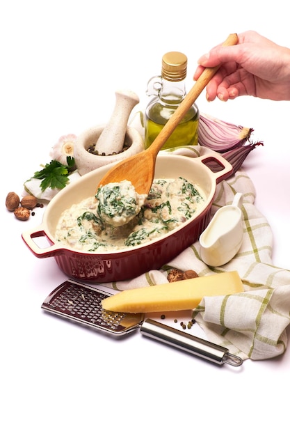 Chef preparing a meal with herbs and vegetables
