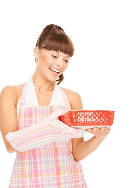 Smiling person holding a cooked dish